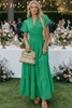 Woman wearing green maxi dress with puff sleeves