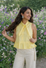 Woman wearing yellow peplum blouse 