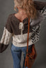 Back view of color block sweater with tie detail 